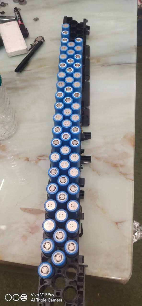 Battery pack dismantled by hand — cells removed from their module holder